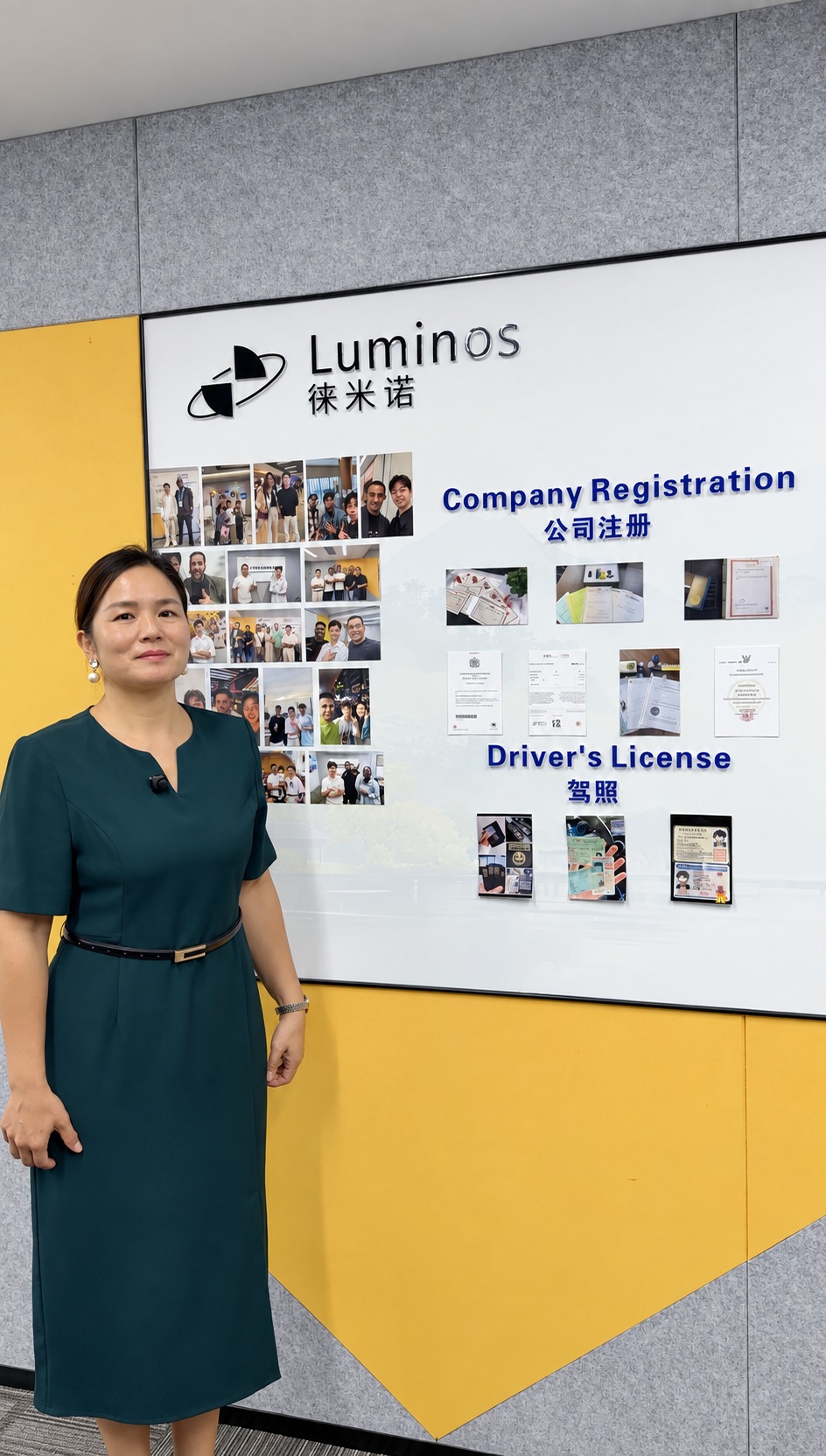 A Luminos team member standing beside the office signage